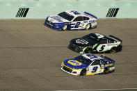 Brad Keselowski (2) Kyle Larson (5) and Chase Elliott (9) battle for position as they round turn four during a NASCAR Cup Series auto race, Sunday, Feb. 28, 2021, in Homestead, Fla. (AP Photo/Wilfredo Lee)