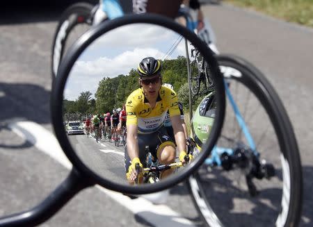 Etixx-Quick Step rider Tony Martin of Germany, race leader's yellow jersey, is reflected in a motorbike mirror as he cycles during the 191.5-km (118.9 miles) 6th stage of the 102nd Tour de France cycling race from Abbeville to Le Havre, France, July 9, 2015. REUTERS/Eric Gaillard