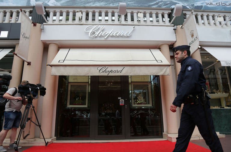 An anti-riot police officer patrols outside a Chopard store in Cannes, southern France, on May 17, 2013 after jewellery worth more than one million dollars made by the Swiss luxury watchmaker and jeweller was stolen at the Novotel Hotel during the 66th edition of the Cannes Film Festival in Cannes