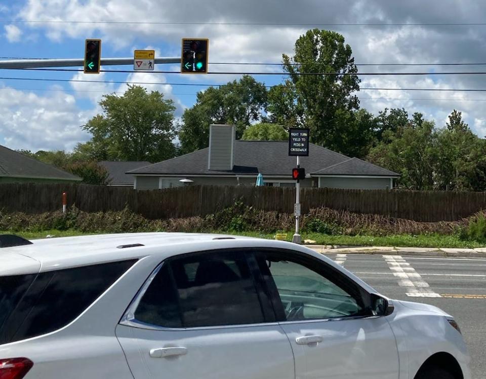 A traffic control warns drivers to yield to pedestrians in this crosswalk on Collins Road near Interstate 295 in Jacksonville's Westside.