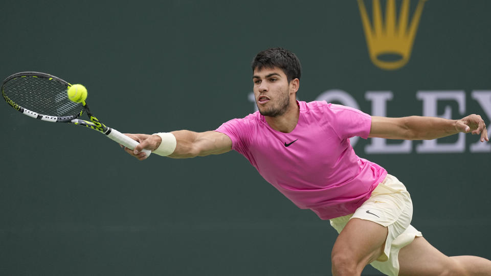 Carlos Alcaraz, of Spain, returns a shot against Daniil Medvedev, of Russia, during the men's singles final at the BNP Paribas Open tennis tournament Sunday, March 19, 2023, in Indian Wells, Calif. (AP Photo/Mark J. Terrill)