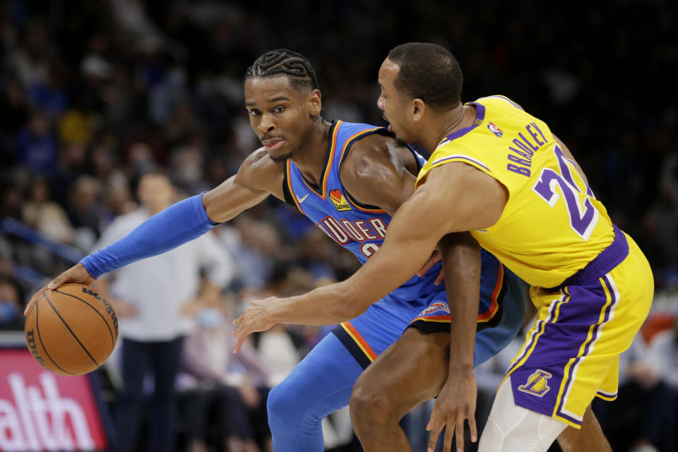 Oklahoma City Thunder guard Shai Gilgeous-Alexander (2) goes against Los Angeles Lakers guard Avery Bradley (20) during the second half of an NBA basketball game, Wednesday, Oct. 27, 2021, in Oklahoma City. (AP Photo/Garett Fisbeck)