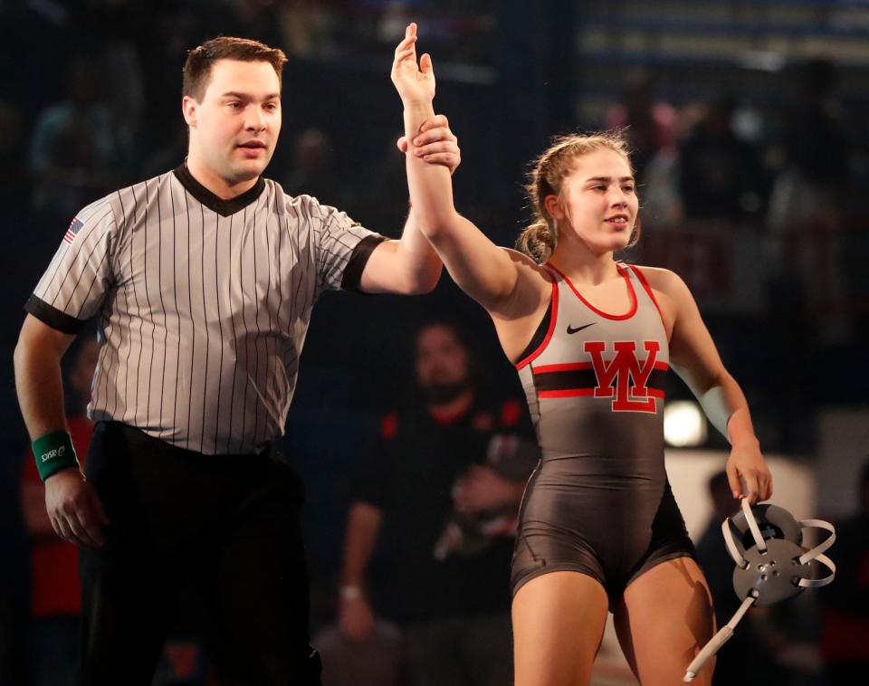 West Lafayette’s Rose Kaplan has her hand held up after winning the 120-pound championship bout, Friday, Jan. 12, 2024, during the Indiana High School Girls Wrestling state finals at Memorial Gymnasium in Kokomo, Ind.