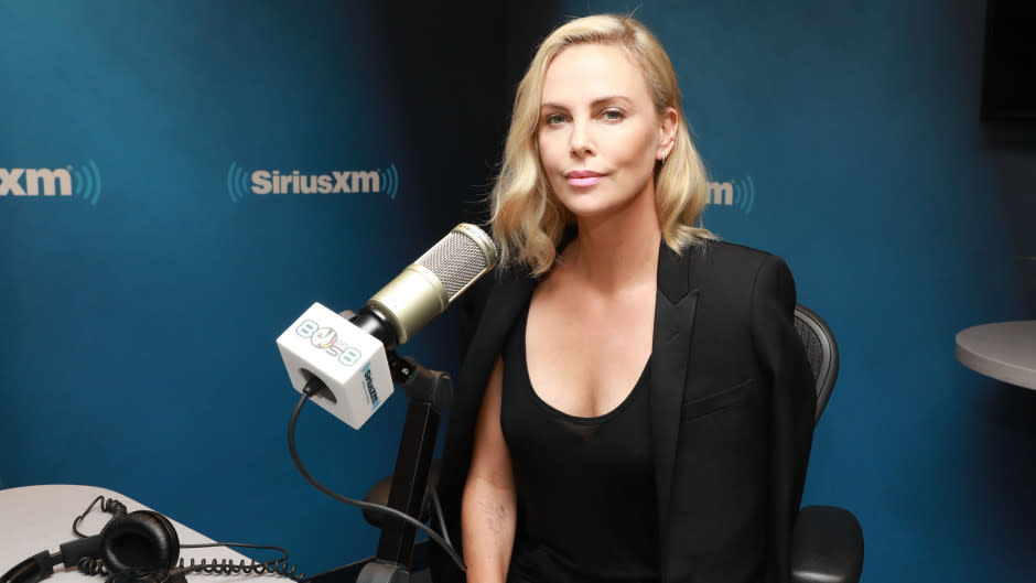 Charlize Theron sitting in front of a microphone at a Sirius XM Town Hall event