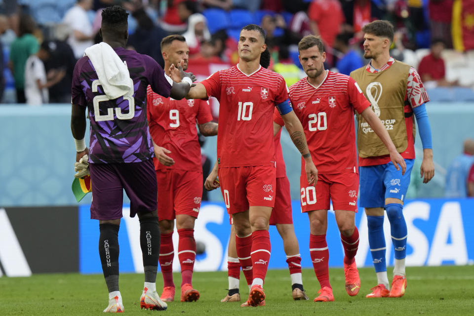 Switzerland's Granit Xhaka greets Cameroon's goalkeeper Andre Onana at the end of the World Cup group G soccer match between Switzerland and Cameroon, at the Al Janoub Stadium in Al Wakrah, Qatar, Thursday, Nov. 24, 2022. Switzerland won 1-0. (AP Photo/Luca Bruno)