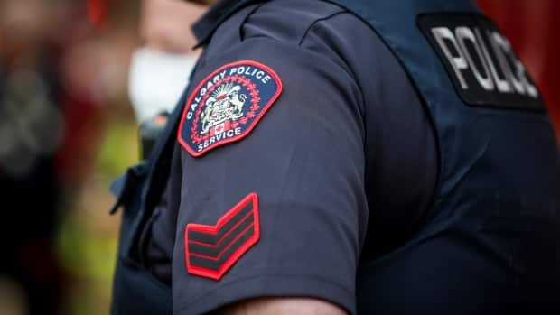 A Calgary Police Service officer is seen in Calgary, Alta., April 14, 2020. Police say since Wednesday, they have received four reports of possible abduction or child-luring attempts.  (Jeff McIntosh/The Canadian Press - image credit)