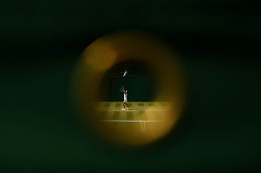 France's Manon Leonard throws the ball to serve during a girls' singles match