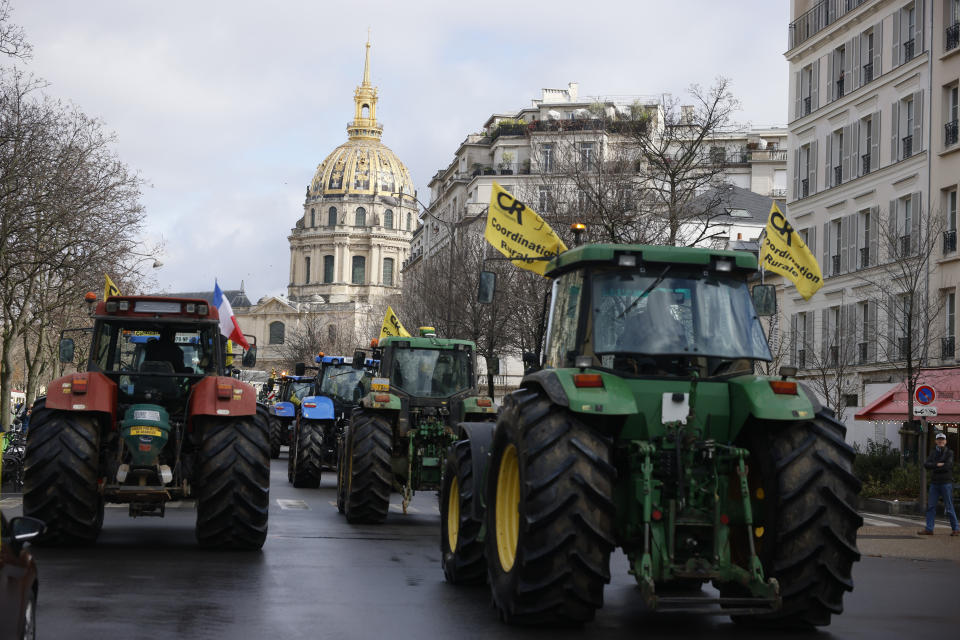Farmers drive their tractors, Friday, Feb. 23, 2024 in Paris. Angry farmers were back to Paris on their tractors in a new protest demanding more government support and simpler regulations, on the eve of a major agricultural fair in the French capital. (AP Photo/Thomas Padilla)