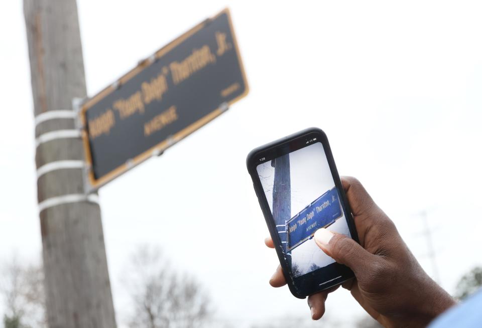 People gather along Dunn Avenue in Memphis during a ceremony renaming the street to honor the late rapper Young Dolph.