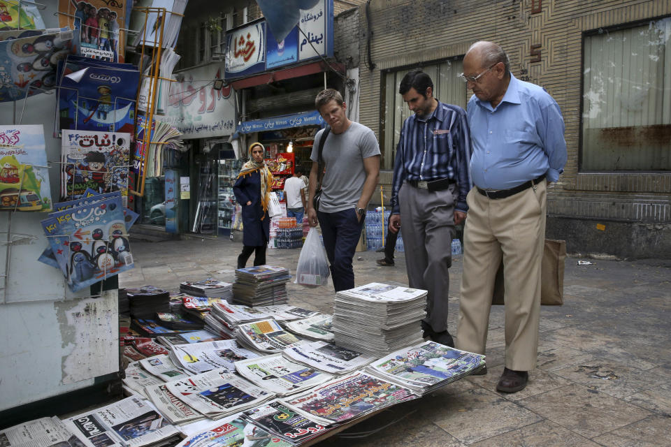 People read the front pages at a news stand in Tehran, Iran, on July 7, 2015.