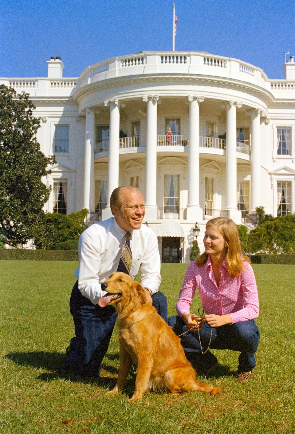 President Gerald Ford and his daughter Susan with their golden retriever Liberty on the South Lawn of the White House in 1974.