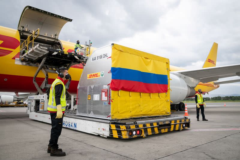 DHL workers unload a batch of doses of the Pfizer-BioNTech COVID-19 vaccine at El Dorado International Airport in Bogota