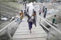 Workers carry bags at a construction site in capital Naypyitaw, January 24, 2012.