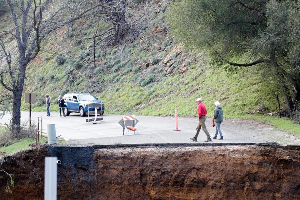 Area residents who were stranded after Chimney Rock Road northwest of Paso Robles washed out during a recent rain storm check out the damage on Saturday, March 11, 2023.