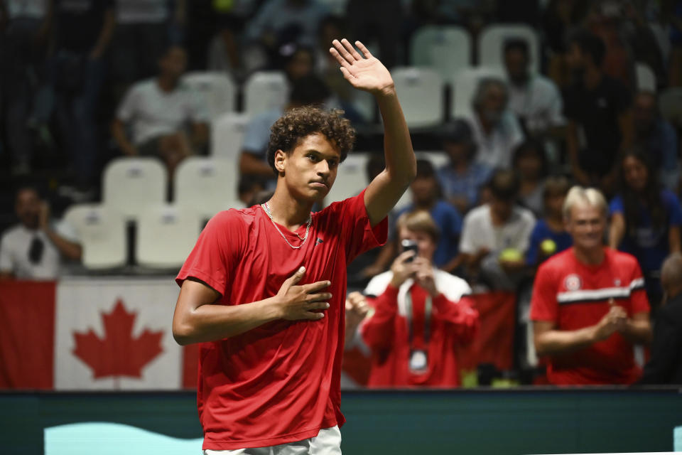 Canada's Gabriel Diallo celebrates victory against Italy's Lorenzo Musetti during the Davis Cup group stage tennis match at the Unipol Arena, Bologna, Italy, Wednesday, Sept. 13. 2023. (Massimo Paolone/PA via AP)