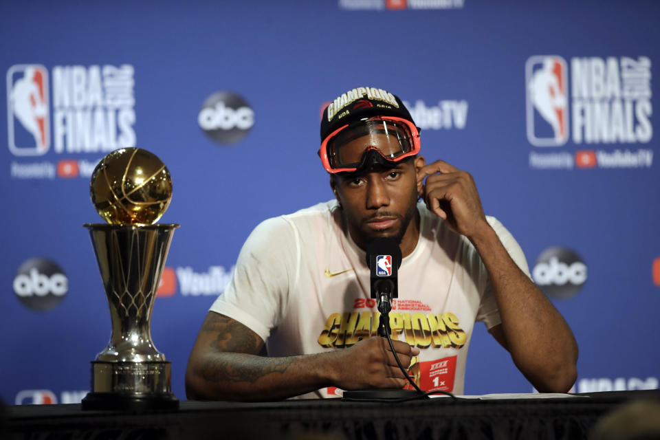 Toronto Raptors forward Kawhi Leonard speaks at a news conference alongside the NBA Finals Most Valuable Player trophy after the Raptors defeated the Golden State Warriors in Game 6 of basketball's NBA Finals in Oakland, Calif., Thursday, June 13, 2019. (AP Photo/Ben Margot)