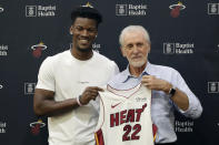 Miami Heat guard Jimmy Butler, left, holds his new jersey as he stands with Miami Heat president Pat Riley, during an NBA basketball news conference, Friday, Sept. 27, 2019, in Miami. Butler spoke publicly for the first time since the July trade that brought him to South Florida as the new face of the franchise. (AP Photo/Lynne Sladky)