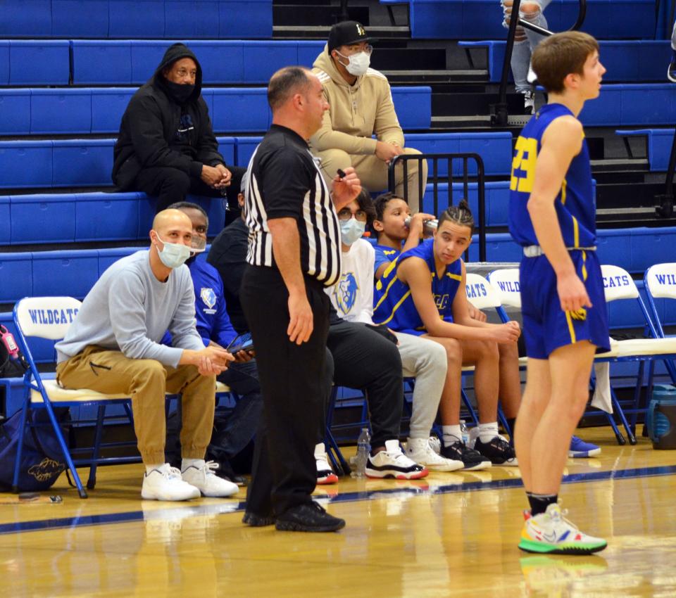 Broadfording boys basketball coach Brandon Monroe, left, talks with a referee during the Lions' recent road game against Williamsport.