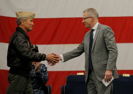 U.S. Navy Admiral Harry Harris (L), Commander of the U.S. Pacific Command, shakes hands with Australian Minister for Urban Infrastructure Paul Fletcher during a ceremony for Talisman Saber 2017, a biennial joint military exercise between the United States and Australia aboard the USS Bonhomme Richard amphibious assault ship in the Pacific Ocean off the coast of Sydney, Australia, June 29, 2017. REUTERS/Jason Reed