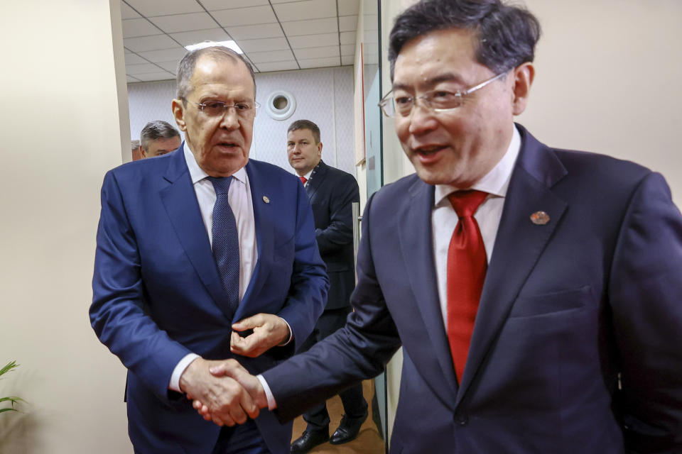 In this handout photo released by Russian Foreign Ministry Press Service, Russian Foreign Minister Sergey Lavrov, left, and Chinese Foreign Minister Qin Gang shake hands on the sideline of G20 foreign minister's meeting in New Delhi, India, Thursday, March 2, 2023. (Russian Foreign Ministry Press Service via AP)