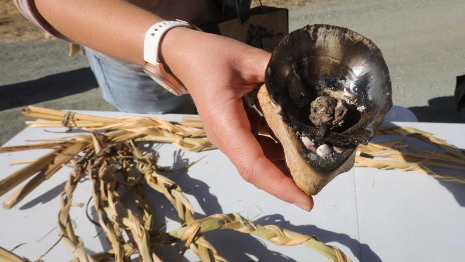 Yak tit?u tit?u yak tilhini Northern Chumash Tribe cultural burn practitioner Becca Lucas holds resin coals used to light torches and begin the fire on June 18, 2024.