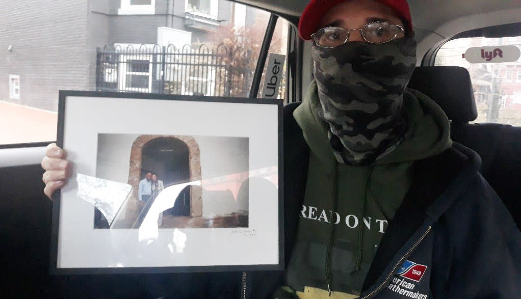 Kevin Lyons with a framed photo of Nancy Pelosi and John Lewis from Pelosi's office on Jan. 6, 2021. (USDC District of Columbia)