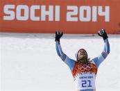 Norway's winner Kjetil Jansrud celebrates on podium during a flower ceremony after the men's alpine skiing Super-G competition during the 2014 Sochi Winter Olympics at the Rosa Khutor Alpine Cente February 16, 2014. REUTERS/Mike Segar