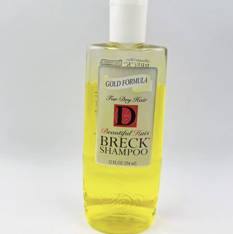 A bottle of Breck shampoo with the label reading "Gold Formula, For Dry Hair, Beautiful Hair, Breck Shampoo, 12 FL OZ (354 mL)"