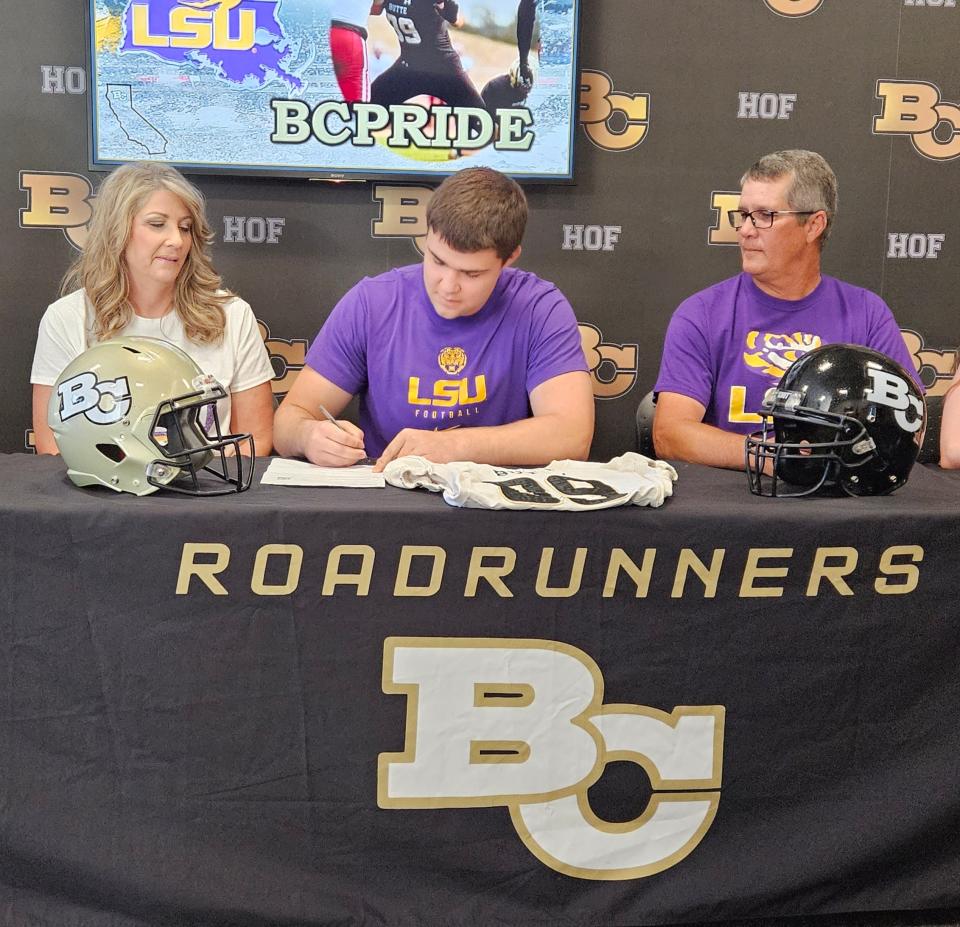 U-Prep 2022 graduate and Butte College tight Connor Gilbreath signs to LSU on Tuesday, July 25, 2023 while joined by his mother Shelly Gilbreath (left) and Jeff Gilbreath (right).