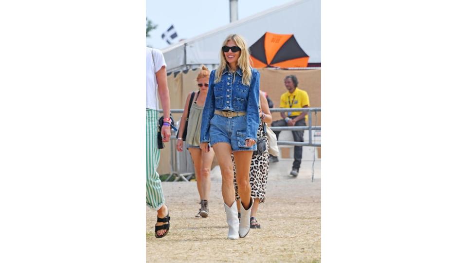 Sienna Miller in double denim jacket and mini shorts at Glastonbury Festival