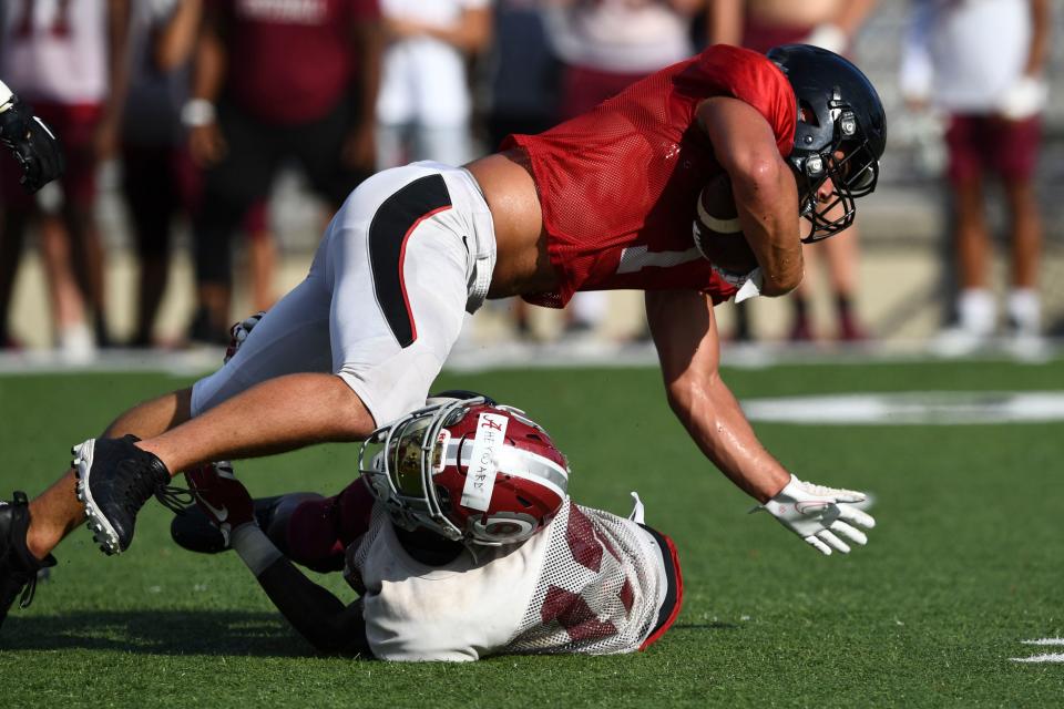 Maryville's Gage LaDue is stopped by Oak Ridge's Brandon Heyward during a scrimmage at Maryville on Friday, August 4, 2023.