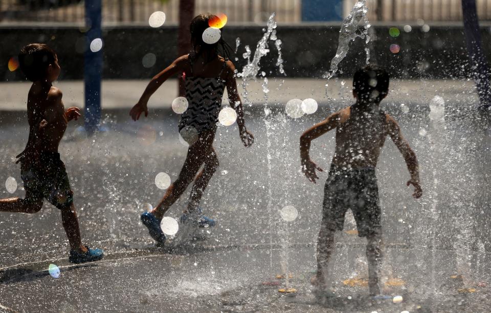 Children play in the water at Riverview Park in Mesa on July 6, 2020.