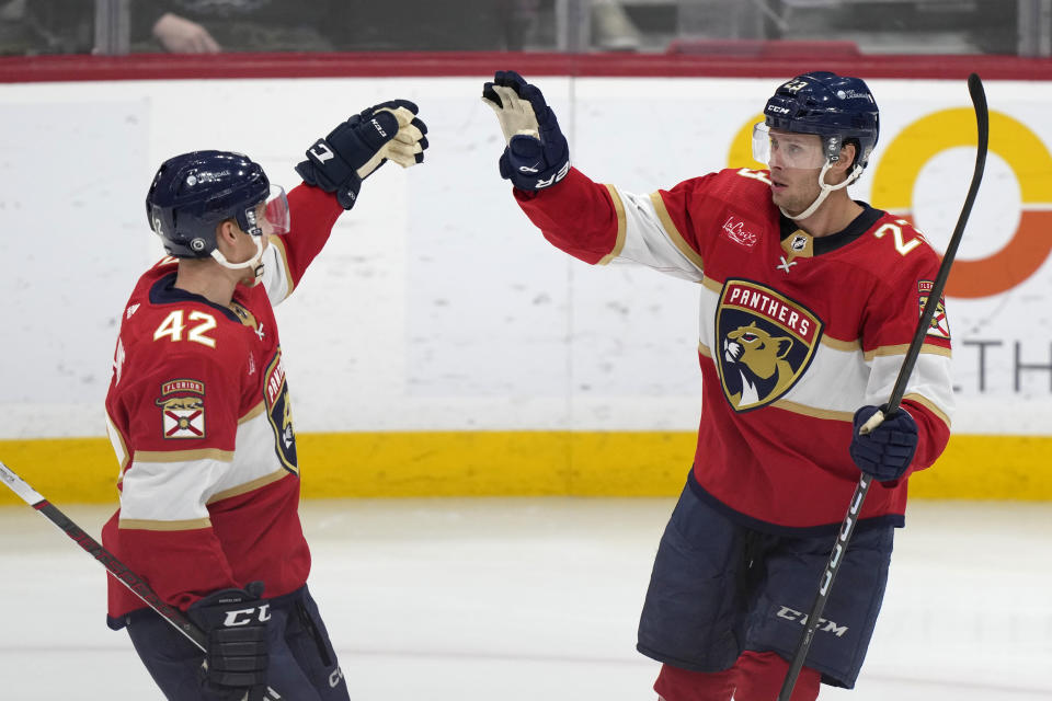 Florida Panthers center Carter Verhaeghe (23) is congratulated by defenseman Gustav Forsling (42) after Verhaeghe scored during the second period of an NHL hockey game against the Toronto Maple Leafs, Tuesday, April 16, 2024, in Sunrise, Fla. (AP Photo/Wilfredo Lee)