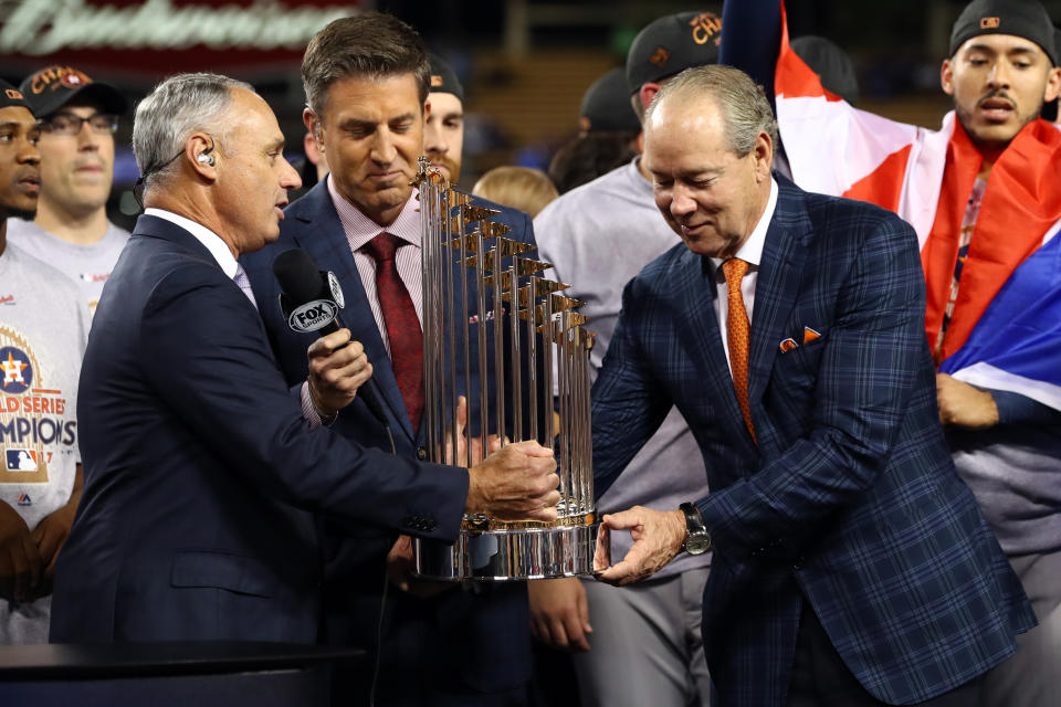 LOS ANGELES, CA - NOVEMBER 1:  Major League Baseball Commissioner Robert D. Manfred Jr. presents the Commissioner's Trophy to the Houston Astros owner Jim Crane after the Astros defeated the Los Angeles Dodgers in Game 7 of the 2017 World Series at Dodger Stadium on Wednesday, November 1, 2017 in Los Angeles, California. (Photo by Alex Trautwig/MLB via Getty Images) 