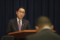 Japanese Prime Minister Fumio Kishida listens to a reporter's question during a news conference in Tokyo, Wednesday, March 16, 2022. Kishida on Wednesday announced plans to fully lift coronavirus restrictions on March 21 as new infections driven by the highly contagious omicron variant slow. (Stanislav Kogiku/Pool Photo via AP)