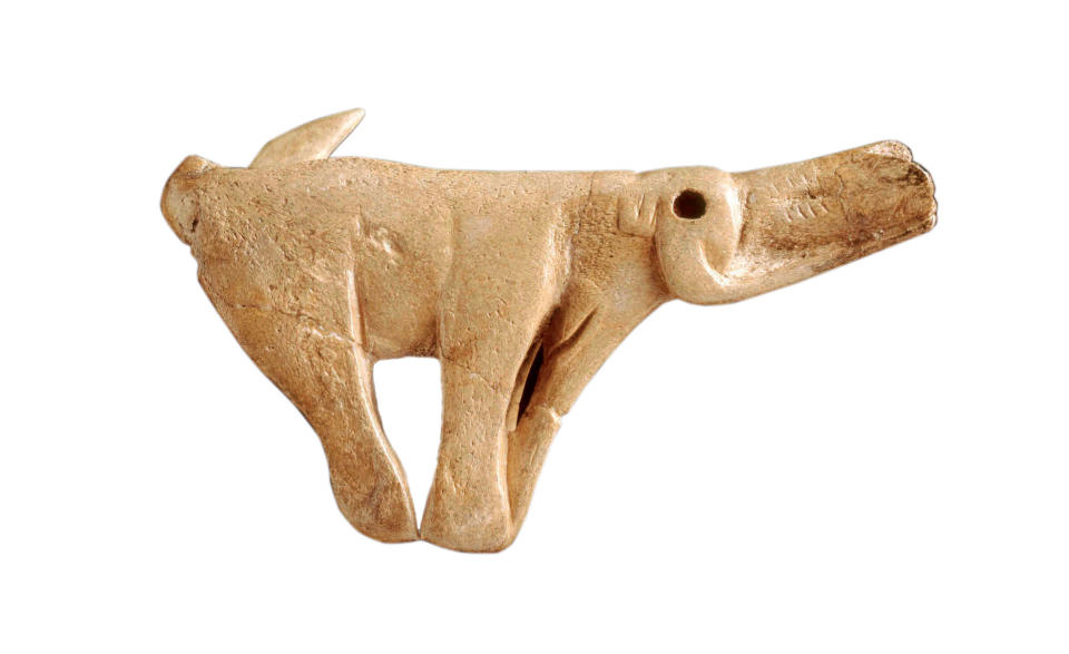 Spear thrower made from reindeer antler, sculpted as a mammoth. Found in the rock shelter of Montastruc, France, the sculpture is estimated to be between 13,000 and 14,000 years old (The Trustees of the British Museum)