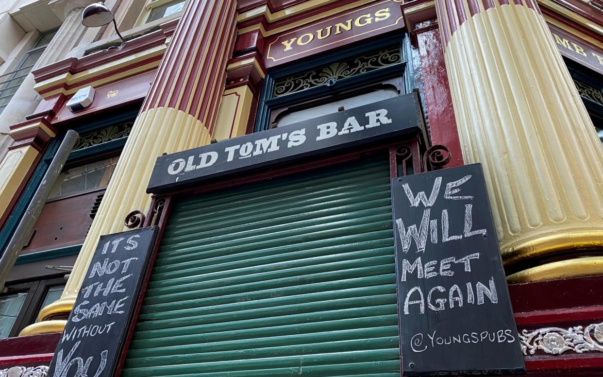 A closed pub in London displays a sign saying 'we will meet again' - Simon Newman/Reuters