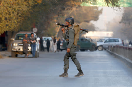 FILE PHOTO: An Afghan police officer keeps watch near the site of a blast in Kabul, Afghanistan October 31, 2017. REUTERS/Omar Sobhani/File Photo