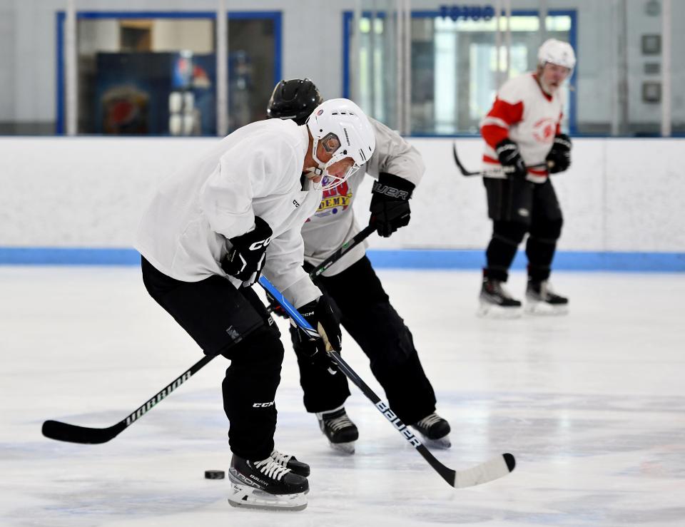 Billy Lynch, 81, of Westborough gets in a battle for the puck during Central Mass Rusty Blades practice.