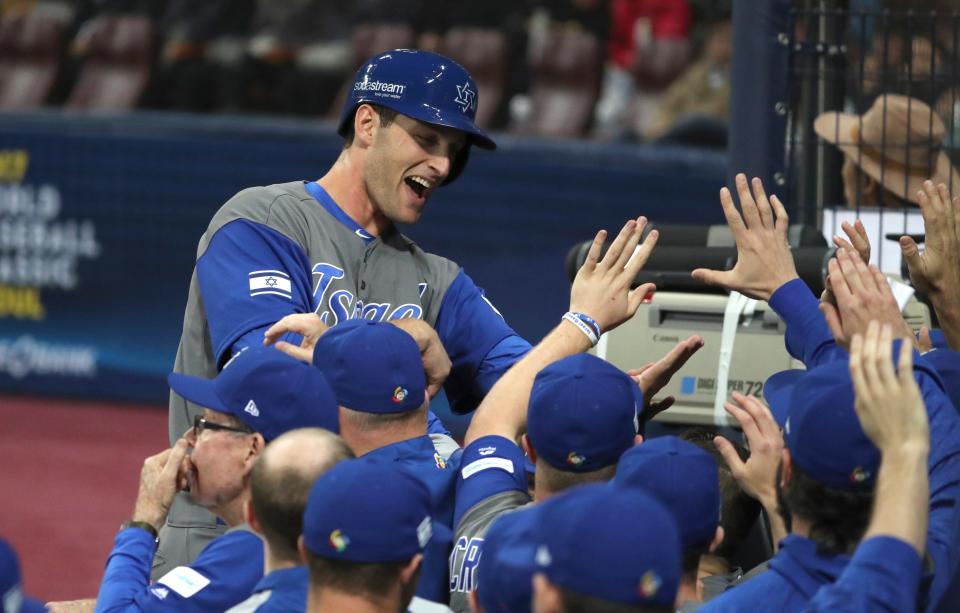 Israel's Nate Freiman celebrates with teammates after a forced run against South Korea during the second inning of their first round game of the World Baseball Classic at Gocheok Sky Dome in Seoul, South Korea, Monday, March 6, 2017. (AP Photo/Lee Jin-man)