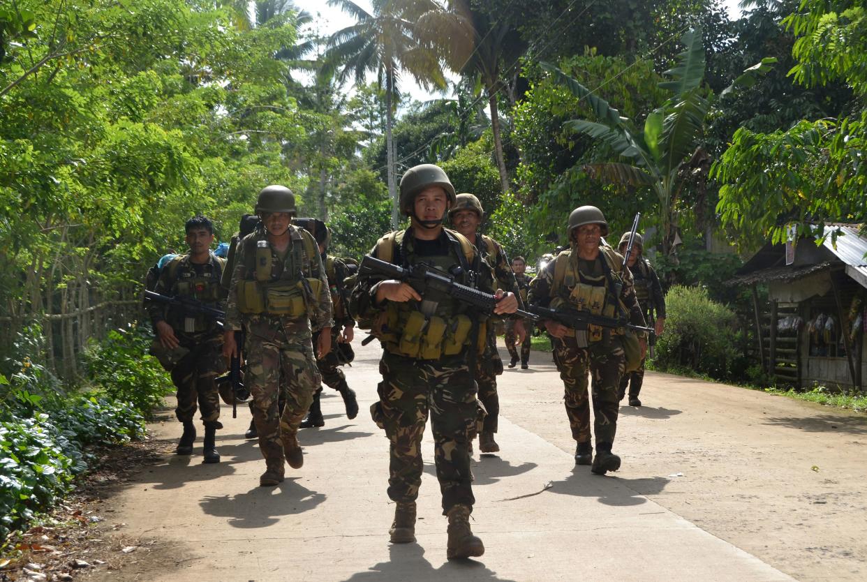 File Photo: Philippine soldiers walking along a highway as they return to camp at the village of Bongkaong, Patikul town, Sulu province on the southern island of Mindanao. (Photo: STRINGER/AFP via Getty Images)