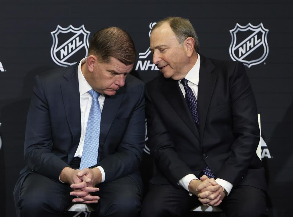 NHLPA executive director Marty Walsh and NHL commissioner Gary Bettman chat during All-Star weekend in Toronto.