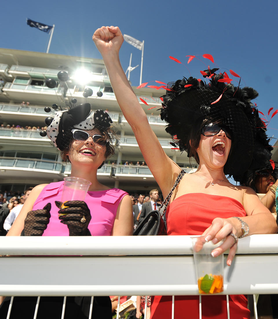 Racegoers cheer during a race on 'Ladies Day' on the first day of the Epsom Derby Festival, in Surrey, southern England, on June 3, 2011. The Epsom Derby race will be run on Saturday June 4, 2011. AFP PHOTO / BEN STANSALL (Photo credit should read BEN STANSALL/AFP/Getty Images)