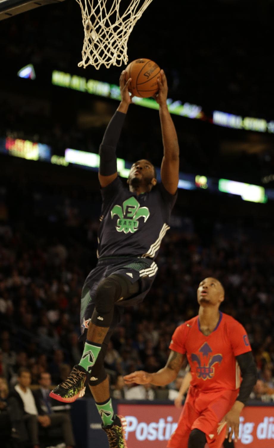 East Team John Wall, of the Washington Wizards (2) drives to the hoop as West Team's Damian Lillard, of the Portland Trail Blazers (0) looks on during the NBA All Star basketball game, Sunday, Feb. 16, 2014, in New Orleans. (AP Photo/Gerald Herbert)