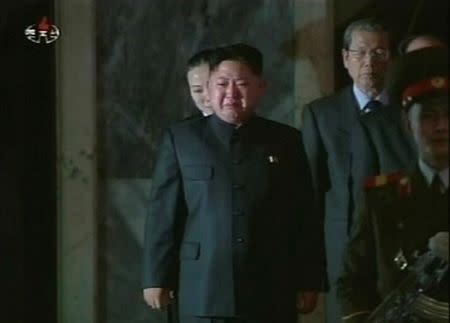 FILE PHOTO: North Korea's new leader Kim Jong-un cries as his father, North Korea's late leader Kim Jong-il, lies in state during the run-up to his funeral in Pyongyang in this still image taken from video broadcast on December 27, 2011. To match Insight NORTHKOREA-KIMJONGUN/ REUTERS/KCNA via Reuters TV/File Photo