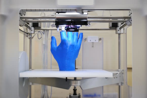 3D printing a blue hand.