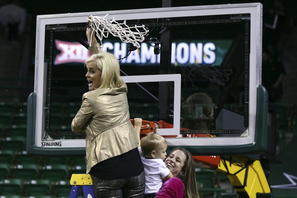 Baylor head coach Kim Mulkey cuts the net down with her daughter, assistant coach Makenzie Fuller, and Fuller's son, Kannon Reid Fuller, after defeating Kansas State in an NCAA college basketball game, Saturday, Feb. 29, 2020, in Waco, Texas. (AP Photo/Rod Aydelotte)