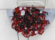 Canada's players huddle as they celebrate defeating Sweden in their men's ice hockey gold medal game at the Sochi 2014 Winter Olympic Games February 23, 2014. REUTERS/Mark Blinch (RUSSIA - Tags: SPORT ICE HOCKEY OLYMPICS)