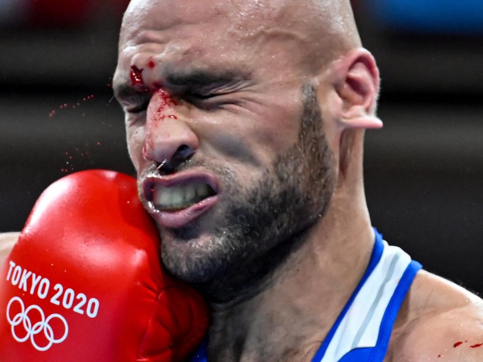 A Jordan boxer takes a punch to the face in the Tokyo Olympics.