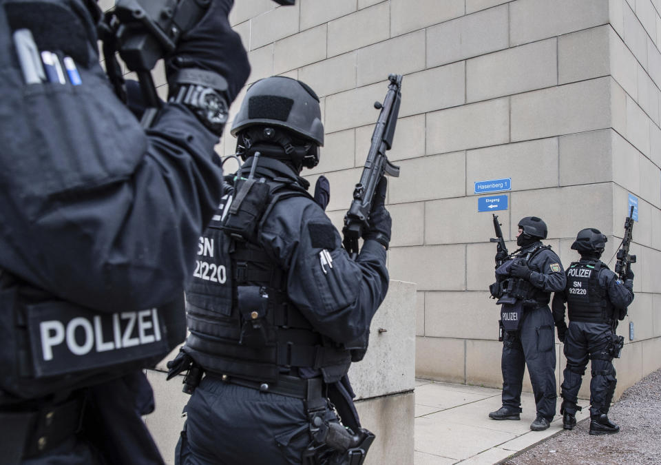 CORRECTS CITY TO DRESDEN -- Police officers secure a synagogue in Dresden, Germany, Wednesday, Oct. 9, 2019. One or more gunmen fired several shots on Wednesday in the German city of Halle. Police say a person has been arrested after a shooting that left two people dead. (Robert Michael/dpa via AP)